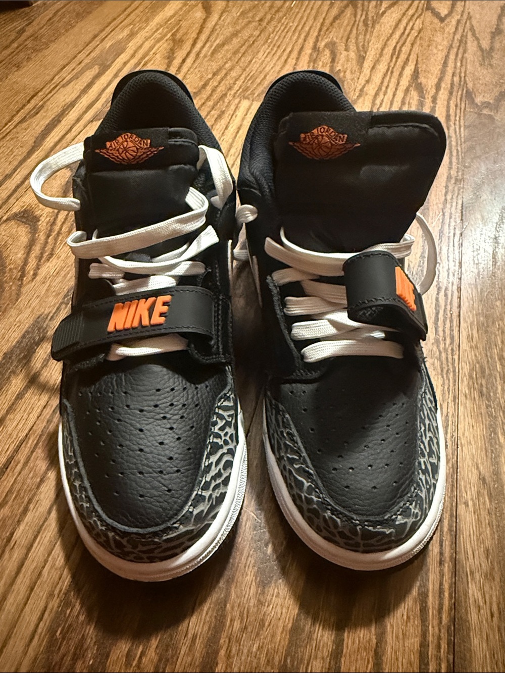 Nike Kids Black Sneakers with Orange Accents and Elephant Print